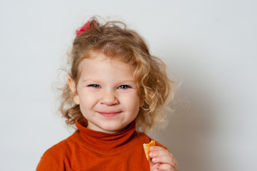 Little, beautiful, emotional girl with cookies in her hand.