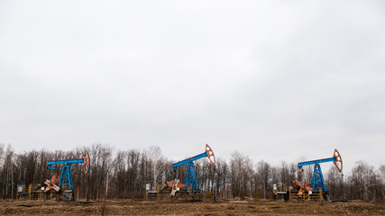 Obraz na płótnie Canvas Green Oil pump oil rig energy industrial machine for petroleum crude. oil crisis. Russia pumps oil pollution.