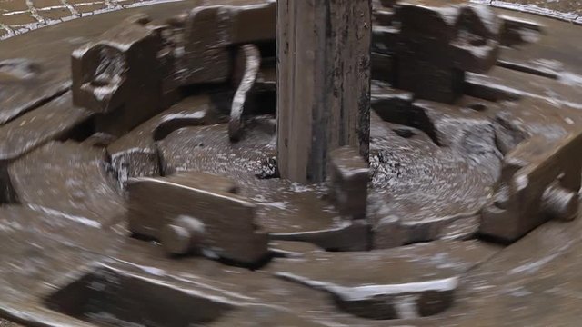 Slip on the rotary table while drilling oil well and pipe being rotated. Stickup and rotary table on an offshore oil rig. Drilling string in the rotary table with the slips standby
