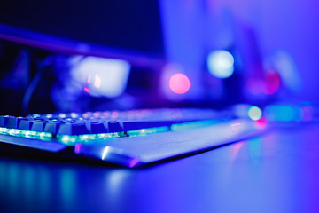 Blurred background professional gamer playing tournaments online games computer with headphones,...