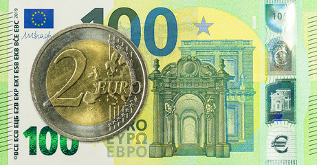 2 euro coin against 100 euro bank note second edition