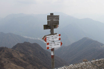 Track signs on a hiking path near Iseo Lake.