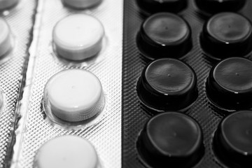 background of black and white packs of pills, yin yang pharmaceuticals