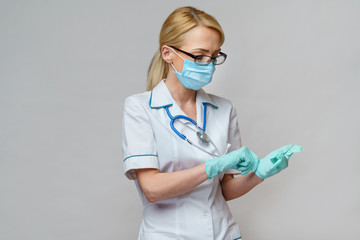 medical doctor nurse woman with stethoscope wearing protective mask and rubber latex gloves