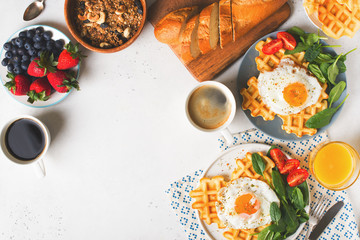 Fried egg, spinach, waffles and cup of coffee espresso, bread, baguette, muesli on white background