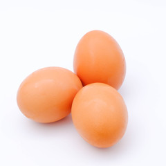 Close-up view of raw chicken eggs on background
