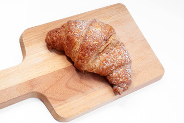 italian cream croissants on wooden and white background
