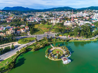 Fototapeta na wymiar Top view aerial photo from flying drone of a Da Lat City with development buildings, transportation. Tourist city in developed Vietnam. 