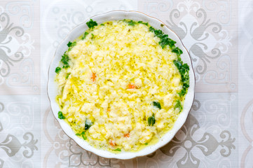 Top view on Polish traditional beef broth with lane kluski noodles.