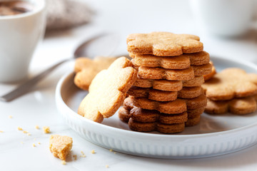 Freshly baked homemade cookies for breakfast with a cup of coffee at the background. Good morning concept