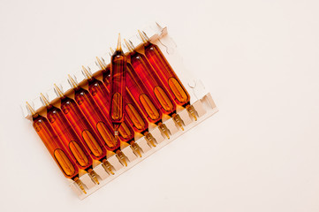 Packing of glass ampoules with a medical preparation shot on a white background.
