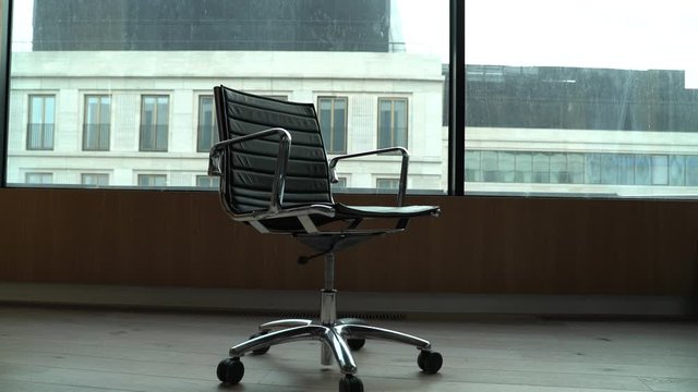 empty chair in the office against the window