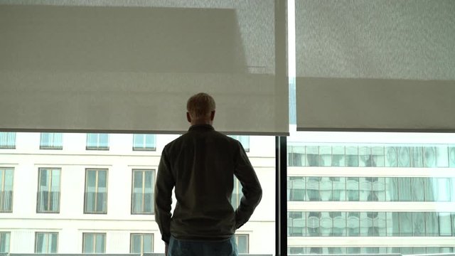 a man in the office on the background of the window talking on the phone