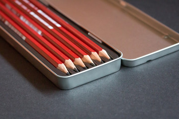 Close up of a set of pencils in a metal box
