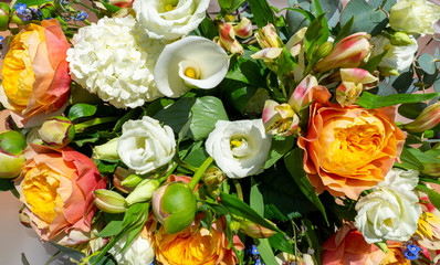 Wonderful bouquet with orange peonies and various flowers. Spring and colorful composition