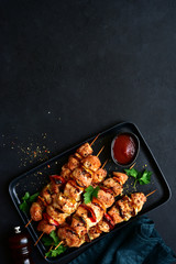 Grilled chicken kebab with vegetables and greens. Top view with copy space.