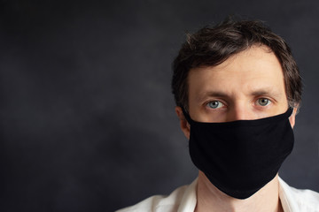 A man in a black mask. Face close up.