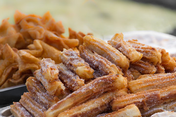 sweet churros and alfajores for sale at the street fair