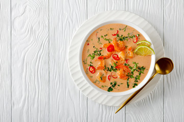 Tom Yum soup in a bowl, top view