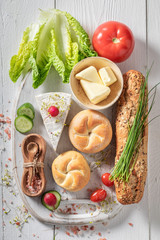 Ingredients for spring sandwich made of lettuce, tomato and chives