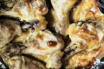 Golden chicken legs in batter fried in a pan