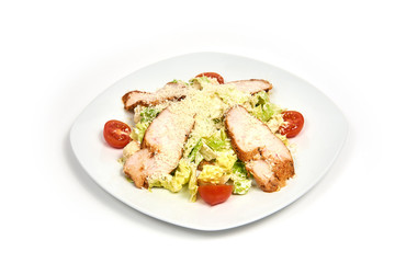 Plate of chicken caesar salad isolated on white background