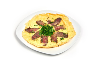 Fried eggs with basturma on a plate on white background