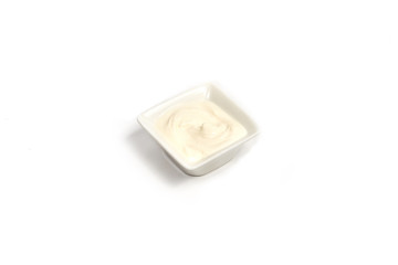 Sour cream sauce in ceramic plate isolated