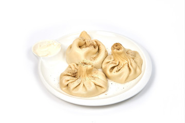 Khinkali on white plate isolated on white background