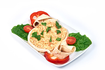 Fried eggs in pita bread on a plate on white background