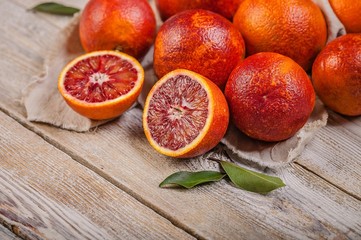 Close-up Juicy Red Sicilian Oranges on a wooden table. Seasonal fruits. Copy space