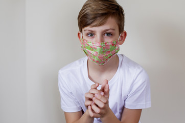 Cute boy wearing medical mask at home. Pandemic coronavirus. Protective mask. Protection against viruses and bacteria.  Mask and COVID-19. Stay home