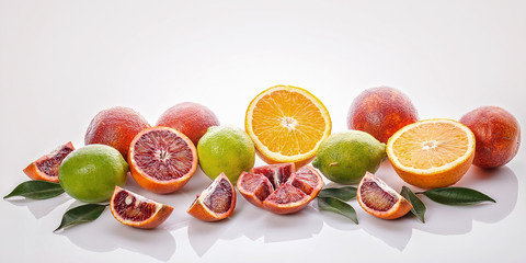 Food banner. Assorted citrus fruits: red Sicilian orange, orange orange and lime on a white background. Seasonal fruits