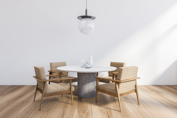 Minimalistic white dining room with round table