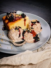 Ice cream coffee and delicious cupcake with strawberry jam on a gray plate. Homemade Dessert. Cook at home. Vertical shot