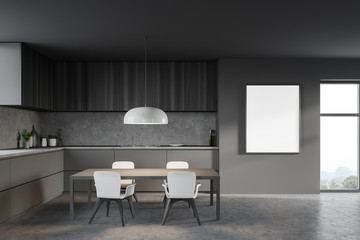 Table and countertops in gray kitchen with poster