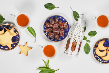 Iftar foods on white table. Traditional middle-eastern lunch with cookies and sweets