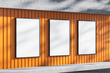 Three blank billboards on orange building wall - obrazy, fototapety, plakaty