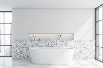 White mosaic bathroom interior with tub