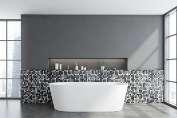 Gray mosaic bathroom interior with tub
