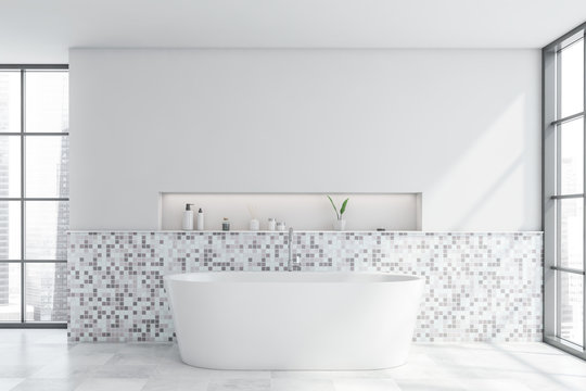 White mosaic bathroom interior with tub