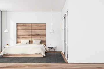 Fototapeta na wymiar White and wood bedroom with mock up wall