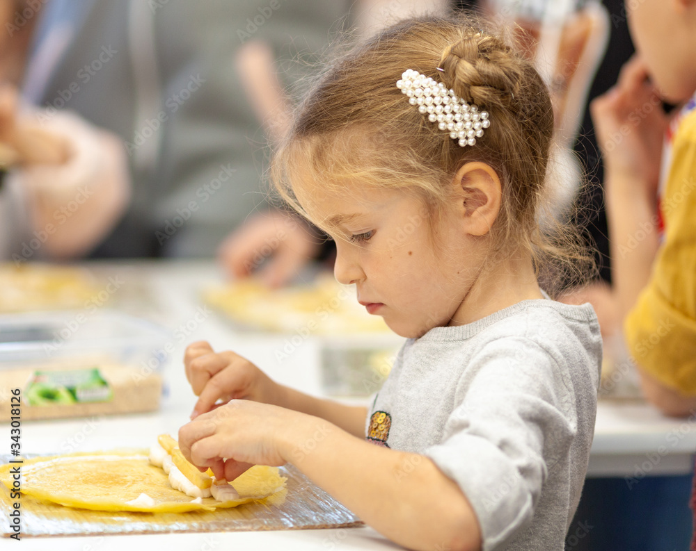 Wall mural girl makes sushi at the culinary master class