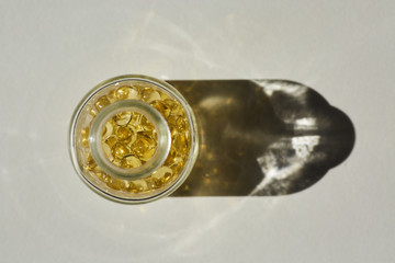 A bottle with capsules with medication, gelatin tablets with oil, vitamin or collagen. A medicinal product or natural cosmetic product.