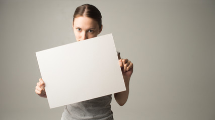 woman holding a sheet of paper in her hand