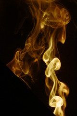 yellow colored smoke on a black background