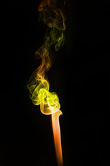 yellow colored smoke on a black background