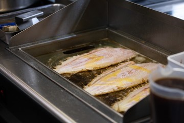 scenes from commercial kitchen preparing food for take away and delivery