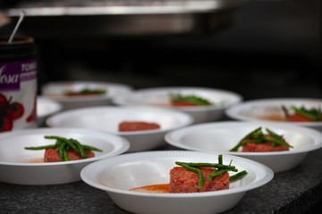 scenes from commercial kitchen preparing food for take away and delivery