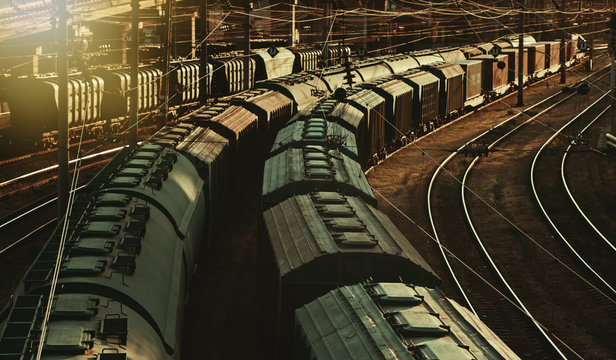 Heavy industry. Old freight train on railway at sunset